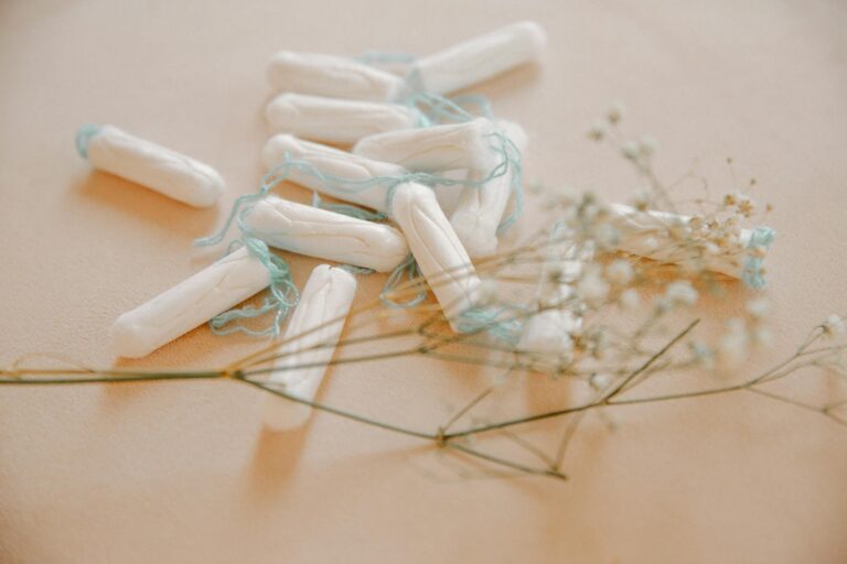 Aesthetic arrangement of tampons with delicate flowers enhancing the composition.